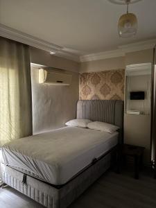a bedroom with a bed in a room at Huzur Otel Ümraniye in Istanbul