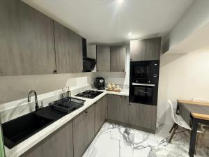 a kitchen with a sink and a stove at Melrose Loft with master suite in Sanary-sur-Mer