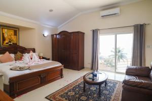 a bedroom with a bed and a living room at Hotel Barmoi in Freetown +107 photos