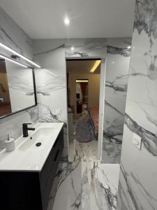 a bathroom with a sink and a mirror at Melrose Loft with master suite in Sanary-sur-Mer