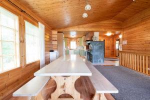 a wooden room with a table in a cabin at Himospeili in Jämsä