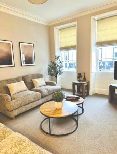 a living room with a couch and a table at HORSEMARKET on the square in Kelso