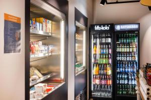 a refrigerator filled with lots of different types of drinks at sylc. Apartmenthotel – Serviced Apartments in Hamburg