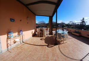 a large patio with a table and chairs on it at Riserva Verde in Castel Porziano