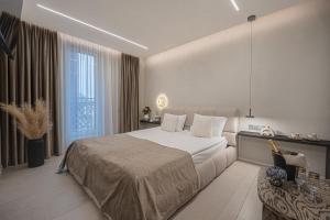 a bedroom with a large bed and a large window at SPA apartamentai Palanga in Palanga