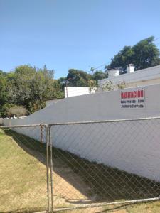 a chain link fence in front of a building at Habitacion - Tercio in São Gabriel +1 photo