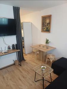 a living room with a table and a dining room table at Crystal Baltic Studio Gdańsk self check in - 24h in Gdańsk