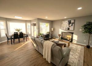 a living room with a couch and a dining room at Cozy Modern Villa in New Castle +3 photos