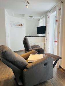 a living room with a couch and a chair at Lieblingsplatz in Kappeln