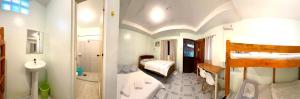 a bathroom with two bunk beds and a bathroom with a sink at Juban Guest House in Pooc