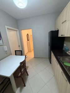 a kitchen with a white table and a table and a table and a tablektop at Ferit's Property Near Astir in Tirana