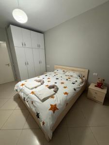 a bedroom with a bed with autumn leaves on it at Ferit's Property Near Astir in Tirana