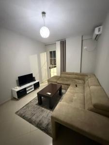 a living room with a couch and a coffee table at Ferit's Property Near Astir in Tirana