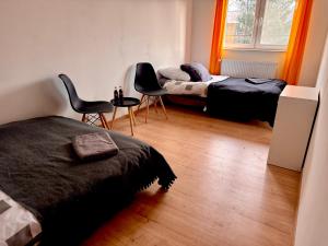 a bedroom with two beds and a table and chairs at Silesia młyn in Katowice