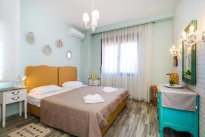 a hotel room with two beds and a window at Sandra Villa Nea Skioni several steps from the sea in Nea Skioni