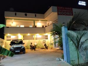 a car parked in front of a building at night at Hotel ZB comforts MYSORE in Mysore +6 photos