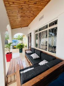 a living room with a couch and a wooden table at COZY NYUMBA in Arusha