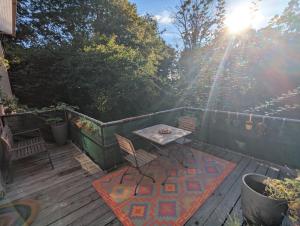 a patio with a table and chairs on a deck at Maisonette am Glockenturm in Südbrookmerland
