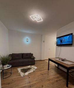 a living room with a couch and a flat screen tv at Tina in Privlaka