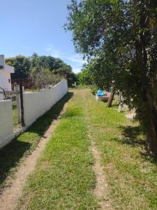 an empty yard with a fence and a tree at Habitacion - Tercio in São Gabriel