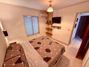 a bedroom with a large bed in a room at Tucuman 890 in Villa María