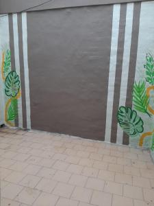 a garage door with plants painted on the side of it at Tucuman 890 in Villa María