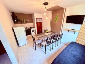 a kitchen and dining room with a table and chairs at Tucuman 890 in Villa María