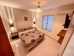 a bedroom with a bed in the middle of a room at Tucuman 890 in Villa María