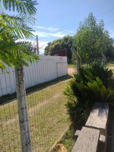 a fence with a bench in a yard at Habitacion - Tercio in São Gabriel