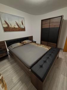 a large bed in a room with a large window at Tina in Privlaka