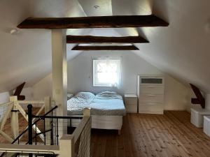a attic bedroom with a bed and a window at Sörbyvägen 6 in Floby