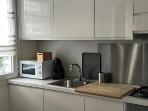 a kitchen with a sink and a microwave at Civico6 in Tirano +31 photos