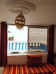 a window in a room with a view of the ocean at Taghazout Beachside Haven Ocean View Apartment in Taghazout