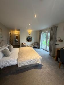 a bedroom with a large bed and a large window at Charnock Farm in Leyland