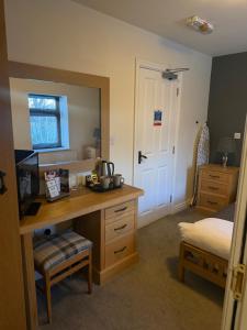 a bedroom with a desk and a bed and a mirror at Charnock Farm in Leyland