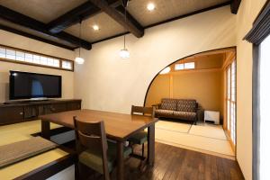 a dining room with a table and a couch at Arai アライ in Takayama