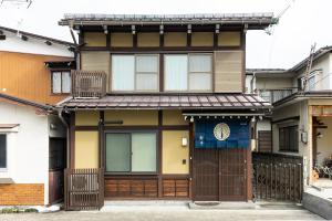 a house with a gate in front of it at Arai アライ in Takayama