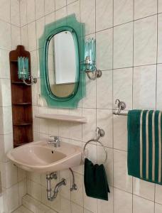 a bathroom with a sink and a mirror at Stadthaus 34 - Check-in 24h in Kevelaer +11 photos