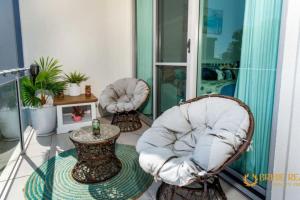 a room with two chairs and a table on a balcony at Sapphire Heaven in Woorim +8 photos