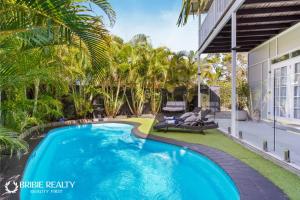 a swimming pool in the backyard of a house at BELLA ABODE AND POOL 4 Bedroom Entertainer in Bongaree