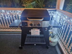 a grill with a sign on it next to a fence at BELLA ABODE AND POOL 4 Bedroom Entertainer in Bongaree