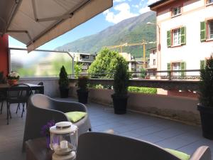 a balcony with chairs and a view of a mountain at Civico6 in Tirano