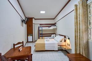 a small room with a bed and a table at SESC ARAXÁ in Araxá +35 photos