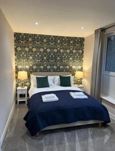 a bedroom with a bed with two towels on it at BROOMBANK, Melrose in Gattonside