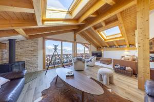 a living room with a table and a fireplace at Chalet Nid Blanc in Nendaz