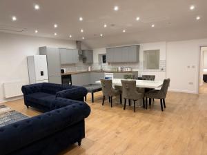 a living room with a couch and a table and chairs at Pear Barn Haven in Wisbech Saint Mary