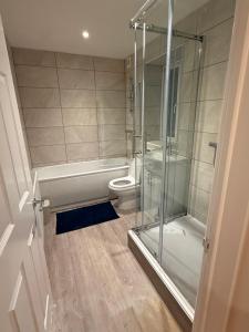 a bathroom with a toilet and a glass shower at Pear Barn Haven in Wisbech Saint Mary +16 photos