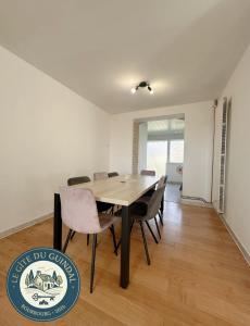 a dining room with a table and chairs at Le Gite Zoé in Bourbourg +17 photos