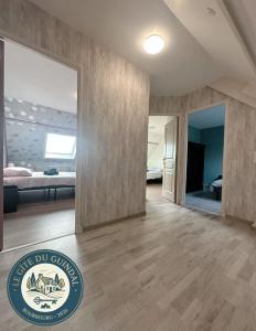 a large living room with a bed and a mirror at Le Gite Zoé in Bourbourg