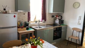 a small kitchen with a sink and a refrigerator at Il Campanile in Fondi